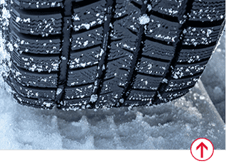 Close up on tire driving on snow