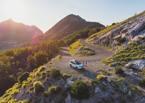 People sitting on car